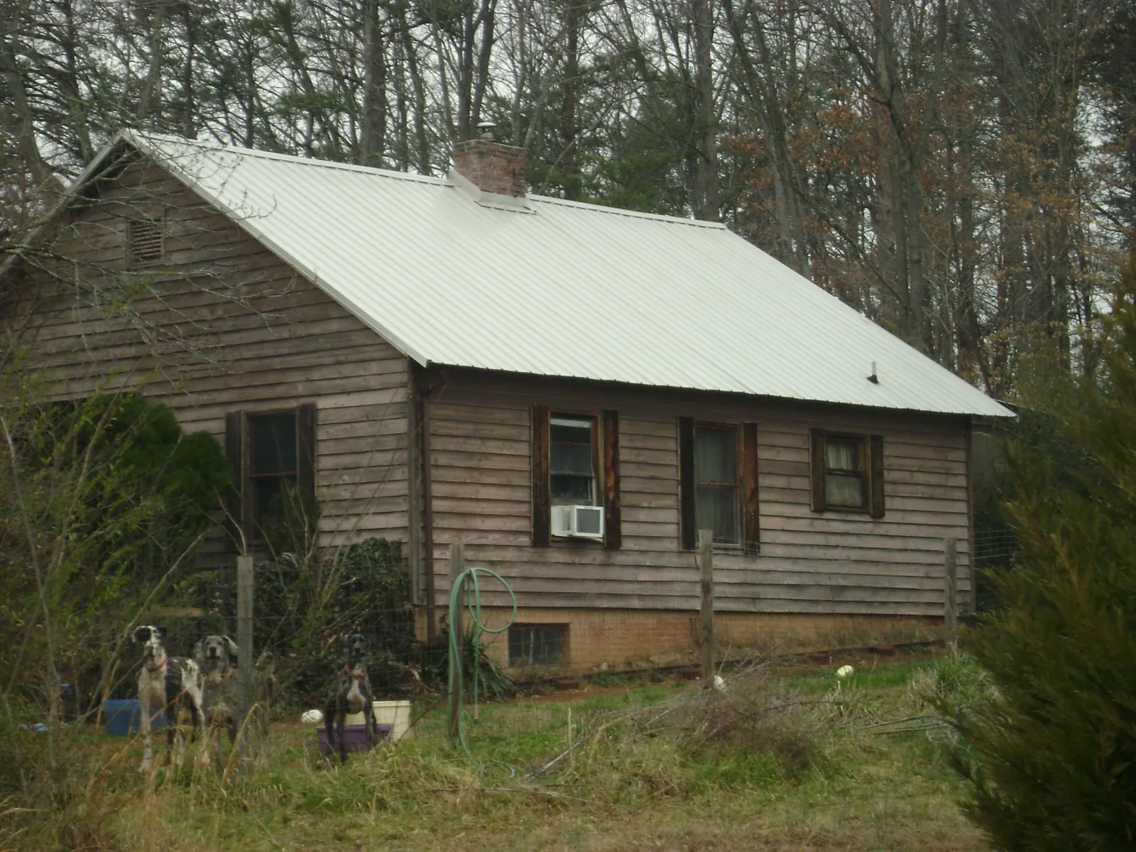 White metal roof on an old wood sided farmhouse, from a Metal Roof Installation job in Quinebaug